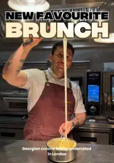 A creator visits Kinkally in London to review their new brunch menu, showcasing a variety of Georgian-inspired dishes including poached eggs with walnut dip, potato bread with scrambled eggs and smoked salmon, slow-braised short rib with polenta, prawn sausages, and a baked matsoni pancake.