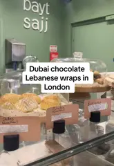 A short video showcasing the preparation of a viral Dubai chocolate wrap and a classic chicken wrap at Bayt Sajj in London, highlighting the menu and affordable pricing.