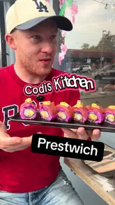 A creator visits Codi's Kitchen in Prestwich, reviewing the beef tartare, bang bang cauliflower, and a signature sushi roll. The video features direct-to-camera commentary and interaction with staff, providing an authentic look at the food and the venue's outdoor seating area.