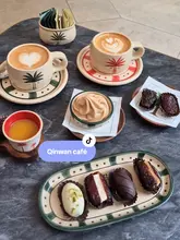 Here are a few options for your SEO alt text, depending on what is most visible in your image:

**Option 1 (Focus on the brand & location):**
"Premium Qinwan dates and date soft serve at the new Qinwan cafe location in London." (82 characters)

**Option 2 (Descriptive & keyword-rich):**
"Coffee and premium Qinwan dates served on a terrace at the new Qinwan cafe in London." (85 characters)

**Option 3 (Focus on the experience):**
"A selection of gourmet dates and coffee at Qinwan cafe, a popular new coffee spot in London." (91 characters)

**Best practice tip:** If the image shows you and your friends, you can add "Friends enjoying..." to the start of any of these options.