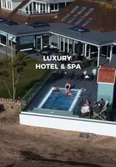 Here are a few options for your SEO alt text (all under 125 characters):

**Option 1 (Descriptive):** 
Luxury sea-view room with a private hot tub overlooking the Firth of Clyde at The Waterside Hotel & Spa in Ayrshire.

**Option 2 (Focus on the experience):**
A relaxing stay at The Waterside Hotel & Spa in Scotland featuring a sea-front room with a private hot tub.

**Option 3 (Concise):**
The Waterside Hotel & Spa in Ayrshire, Scotland, showcasing a luxury sea-view bedroom and outdoor hot tub.

**SEO Tip:** Option 1 is likely your best bet as it includes the specific location and the key selling point (the hot tub/sea view) which users are often searching for.