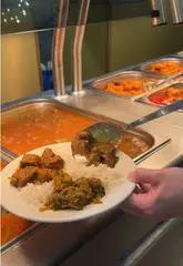 Here are a few options for your SEO alt text, keeping under the 125-character limit:

**Option 1 (Descriptive & SEO-focused):**
A unique rice wall divider separating different curry dishes at The Palm restaurant in Oldham.

**Option 2 (Action-oriented):**
Close up of a creative rice wall display separating various curries at The Palm Indian buffet in Oldham.

**Option 3 (Concise):**
Decorative rice wall used to separate curries at The Palm Indian restaurant in Oldham.

**SEO Tip:** I recommend **Option 1 or 2**, as they include the key terms "Indian restaurant" and "Oldham," which will help your image rank better in local search results.