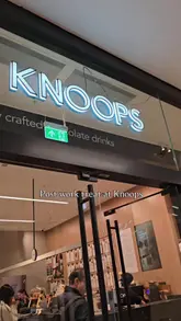 A short, functional video documenting a post-work visit to Knoops, highlighting the loyalty app, the menu selection process based on chocolate percentage, and the final mocha drink.