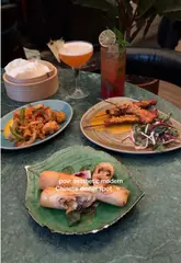 Here are a few options for your SEO alt text, depending on what the photo shows:

**Option 1 (Focus on the food/spread):**
Delicious salt and chilli squid, beef in black bean sauce, and desserts at Mama Yo restaurant on Camden Street, Dublin.

**Option 2 (Focus on the aesthetic/interior):**
Stylish interior of Mama Yo restaurant in Dublin featuring a variety of Chinese dishes from the Lotus Dinner Menu.

**Option 3 (Concise & descriptive):**
Gourmet Chinese dining experience at Mama Yo, Dublin, featuring salt and chilli squid and soft serve ice cream.

**SEO Tip:** I recommend **Option 1** as it includes the specific dishes and the location, which are great for search rankings!
