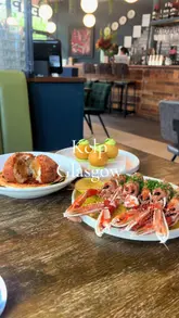 A montage-style video showcasing a variety of seafood-focused dishes at Kelp in Glasgow. The video features close-up shots of plates like langoustines, crab donuts, and Arbroath smokie croquetas, interspersed with shots of a diner enjoying the experience.