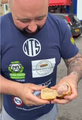 A creator reviews a pork pie from P Turner & Son Butchers in Barnsley, breaking it open to show the filling and sharing his thoughts on the quality and temperature.