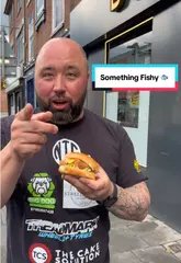 Here are a few options for your SEO alt text, keeping under the 125-character limit:

*   **Option 1 (Descriptive):** A gourmet fish burger from BVRGRY Nottingham, featured in a local food review.
*   **Option 2 (Action-oriented):** Close-up of a crispy fish burger served at BVRGRY restaurant in Nottingham.
*   **Option 3 (Keyword-focused):** Delicious BVRGRY fish burger on a wooden board at a Nottingham food review location.

**Recommendation:** Option 1 is generally best for accessibility and SEO as it clearly defines the subject and the location.