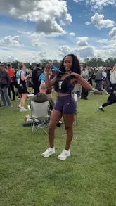 Here are a few options for your alt text, depending on where you want the focus:

**Option 1 (Descriptive & SEO focused):**
Woman in a purple Gymshark outfit doing a celebratory dance after finishing the Hoka Hackney Half Marathon.

**Option 2 (Action-oriented):**
Runner in purple athletic wear celebrating completing her first half marathon at the Hackney Half.

**Option 3 (Concise):**
A runner celebrating after finishing the Hackney Half Marathon wearing a purple Gymshark set. 

**Tip:** Option 1 is generally best for SEO as it includes the brand names and the specific event name.