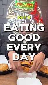 A creator visits a newly opened burger joint in Salford called Bun Mafia, reviewing several items including smash burgers, loaded fries, and spicy chicken tenders.
