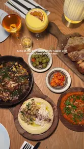 A visually appealing montage showcasing the interior, social atmosphere, and a variety of Mediterranean dishes and cocktails at Amber in London.