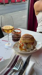 A short, punchy video showcasing a large fish finger sandwich at Belly in Kentish Town. The video features a close-up of the sandwich being cut, revealing the filling, followed by a brief shot of the restaurant interior and a drink.