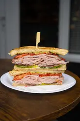 A fast-paced montage showcasing a variety of sandwiches from GNHM in Sketty, South Wales, highlighting the preparation and presentation of their menu items.