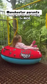 A first-person POV video showcasing the new Forest Tubing activity at Zip World Manchester, featuring a parent and child riding down the slides in a woodland setting.