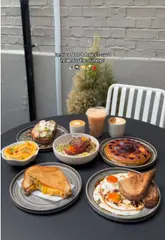 A visually appealing montage showcasing a variety of brunch dishes and specialty coffee at Guillam Coffee House, highlighting their outdoor seating and coffee bean selection.