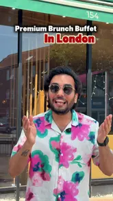 A couple reviews a £15 weekend brunch buffet at an Indian restaurant in London, highlighting the variety of vegetarian dishes available.