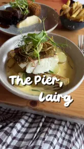 A personal, relaxed reel showcasing a visit to The Pier in Lairg, Scotland. The video features shots of the restaurant's interior, the scenic waterside location, and various dishes including fish, mussels, and dessert, capturing a calm and nostalgic atmosphere.