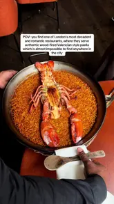 A showcase of Arros QD in London, highlighting their wood-fired Valencian-style paella, specifically the Canadian lobster version, and the restaurant's upscale, romantic interior.
