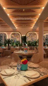 A promotional video showcasing the interior and menu of Nammos Mayfair, a new restaurant in London. The video features smooth pans of the dining area, close-ups of various dishes including burrata, sushi, octopus, pasta, and steak, and highlights the upscale atmosphere.