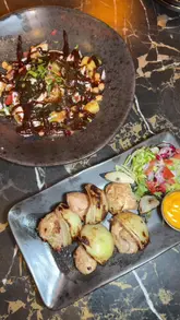 A promotional video for INDARA in Rochdale, featuring a montage of the restaurant's interior and various dishes including naan, curry, burgers, and skewers.