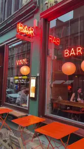 A review of The Left Bank in Glasgow, highlighting its lively atmosphere, music, cocktails, and food menu, including cauliflower bites, seabass, and Eton mess.