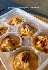 A short, snappy video demonstrating how to elevate store-bought Itsu spicy chicken soup dumplings by adding soy sauce, tahini, and chili oil.