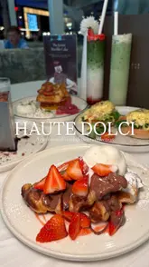 A vlog-style review of Haute Dolci at the Trafford Centre, featuring two creators trying the new summer brunch and dessert menu, including the Matilda cake, Eggs Royale, and various matcha drinks.