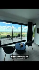 A video tour of 'The Hideaway' cabin at High Hill Farm, showcasing the exterior, interior, private hot tub, and on-site spa facilities including a pool.