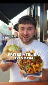 A creator visits Frites Atelier in Soho, London, to review their gourmet fries. The video features the exterior and interior of the shop, the preparation process, and a taste test of several items including iced tea, a cheese croquette, chicken nuggets, and two types of loaded fries: beef stew and basil & parmesan.
