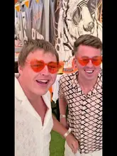 A high-energy vlog-style video featuring two creators attending a daytime party event called 'Novela' at Clwb Crown. The video showcases the lively atmosphere, including live music, dancing, drinks, and food.
