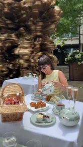 A promotional reel for the Wimbledon-themed afternoon tea at Ham Yard Hotel, featuring close-ups of the picnic-style food, tea service, and the outdoor courtyard setting with a large screen showing tennis matches.