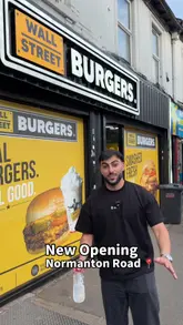 A food review video by a creator visiting a new Wall Street Burgers location in Derby, sampling various menu items including wings, chicken strips, loaded fries, and burgers.