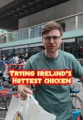 A creator reviews Dave's Hot Chicken in Dublin, testing the spice level of the chicken with friends. The video features candid reactions, interaction with passersby, and a focus on the 'hottest chicken' challenge.