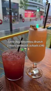 The video provides a straightforward overview of a bottomless brunch experience at Turtle Bay, featuring a variety of cocktails, food dishes like a fried chicken wrap, and the restaurant's interior. It uses text overlays to highlight the price and offer details, accompanied by music.