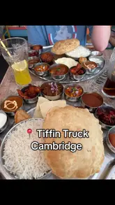 A short, handheld review of a thali meal at Tiffin Truck in Cambridge, featuring the creator trying the food and showing the menu.
