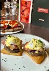 A review of a new brunch spot in Glasgow's Merchant City called Woody's, highlighting their tattie scone benny and breakfast stack, while noting the venue's inclusive atmosphere and entertainment offerings like karaoke.