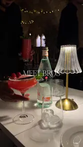 A short, polished montage showcasing the food and interior of Meet Bros steakhouse in London. The video features close-ups of cocktails, a steak sandwich, a lamb shank, pasta, and a chocolate lava cake, interspersed with shots of the restaurant's exterior and atmospheric interior.