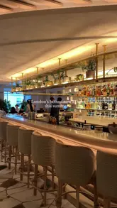 A short, polished montage showcasing the interior design and menu offerings of Nammos London. The video features slow, smooth pans of the restaurant's upscale decor, followed by close-up shots of sushi, pasta, and lamb dishes being served.
