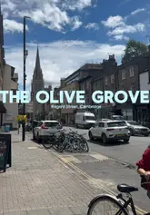 A personal vlog-style review of The Olive Grove in Cambridge, featuring a tour of the exterior and interior, a look at the menu, and a taste test of several Greek dishes including calamari, chicken thighs, and a pork gyros.