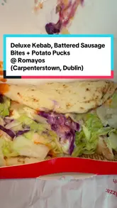 A casual, conversational review of a takeaway meal from Romayo's in Dublin, featuring a Deluxe Kebab, battered sausage bites, potato pucks with curry sauce, and a milkshake. The two creators discuss the food quality and their preferences while eating in a car.