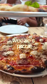 A short review of Weezies in Belgravia, highlighting the crispy pizza, loaded crisps, and chocolate mousse, while noting the no-booking policy.