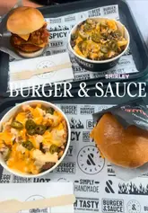 The creator visits a Burger & Sauce location, providing a review of their experience. She highlights specific menu items including the Beef Nacho Melt Burger, Chicken & Cheese Loaded Fries, and a Passionfruit Refresher, while sharing her positive opinion on the flavour and sauce quality.