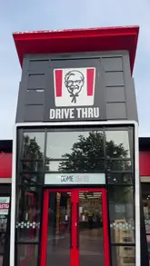 A candid, handheld vlog-style review of the new KFC Tandoori Chicken Burger, covering the ordering process at the drive-thru and a taste test of the burger, fries, and chicken tenders.