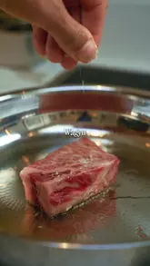 A promotional video for Fine Food Specialist featuring the preparation and consumption of Japanese A5 Wagyu beef at home. The video highlights the marbling and quality of the meat, positioning it as a restaurant-quality experience delivered directly to the consumer.