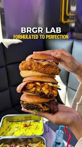 A fast-paced food review reel showcasing a variety of smash burgers, loaded fries, chicken wings, and mocktails at BRGR Lab. The video uses close-up shots to highlight the texture and quality of the food, creating a strong appetite appeal.