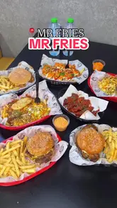 A food review video showcasing various loaded fries, burgers, and chicken tenders at Mr Fries in Birmingham, highlighting the generous portions and indulgent toppings like brisket and lasagna.