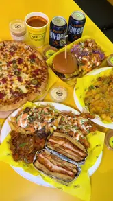 A promotional video for the opening of Mr T's in Glasgow, featuring a montage of their menu items including pizza, burgers, loaded fries, and desserts, alongside shots of the venue's interior and ordering kiosk.
