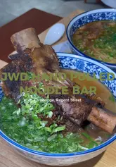 A first-person review of JWD Hand Pulled Noodle Bar in Cambridge, covering the ordering process, the atmosphere, and a taste test of the beef rib noodle soup and cucumber salad.