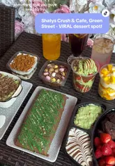 A montage showcasing various viral desserts, including Dubai chocolate bars and crunch cakes, at Shathy's Crush & Cafe, highlighting the cafe's floral decor and indulgent menu items.