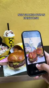 A promotional video for a new Shakedown burger restaurant in Edinburgh, featuring the ordering kiosks, food items, interior decor, and the exterior location.