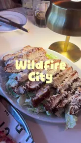 A fast-paced montage showcasing the food and interior of Wildfire City, featuring close-ups of pizza, salad, and donuts, alongside shots of the menu and table settings.